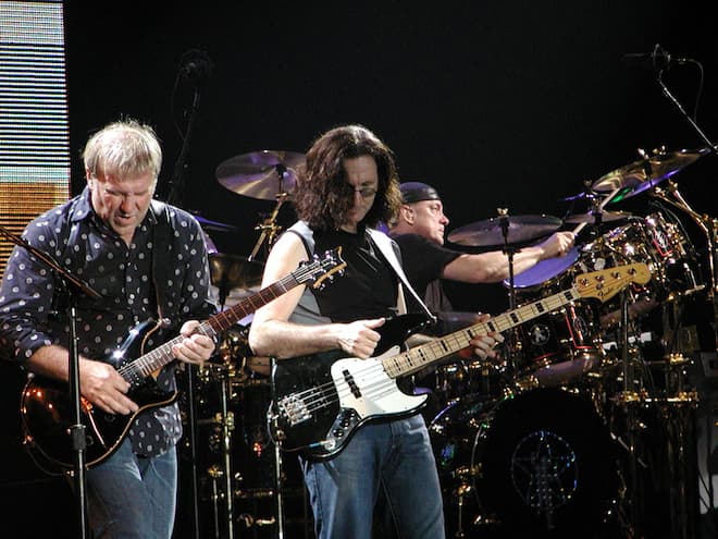 Rush performing in 2004 (left to right): Alex Lifeson, Geddy Lee, Neil Peart